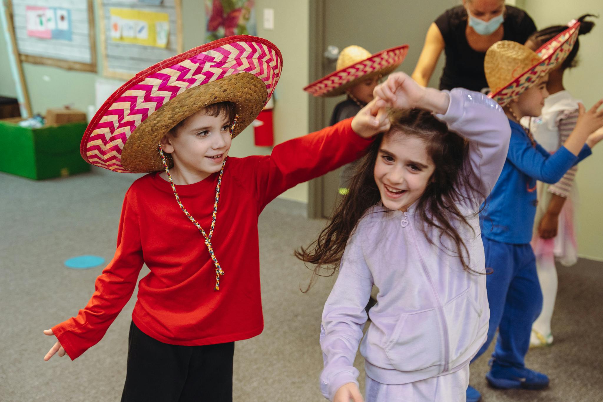 Child in sombrero dancing with another child