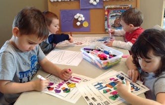 Children coloring at a table
