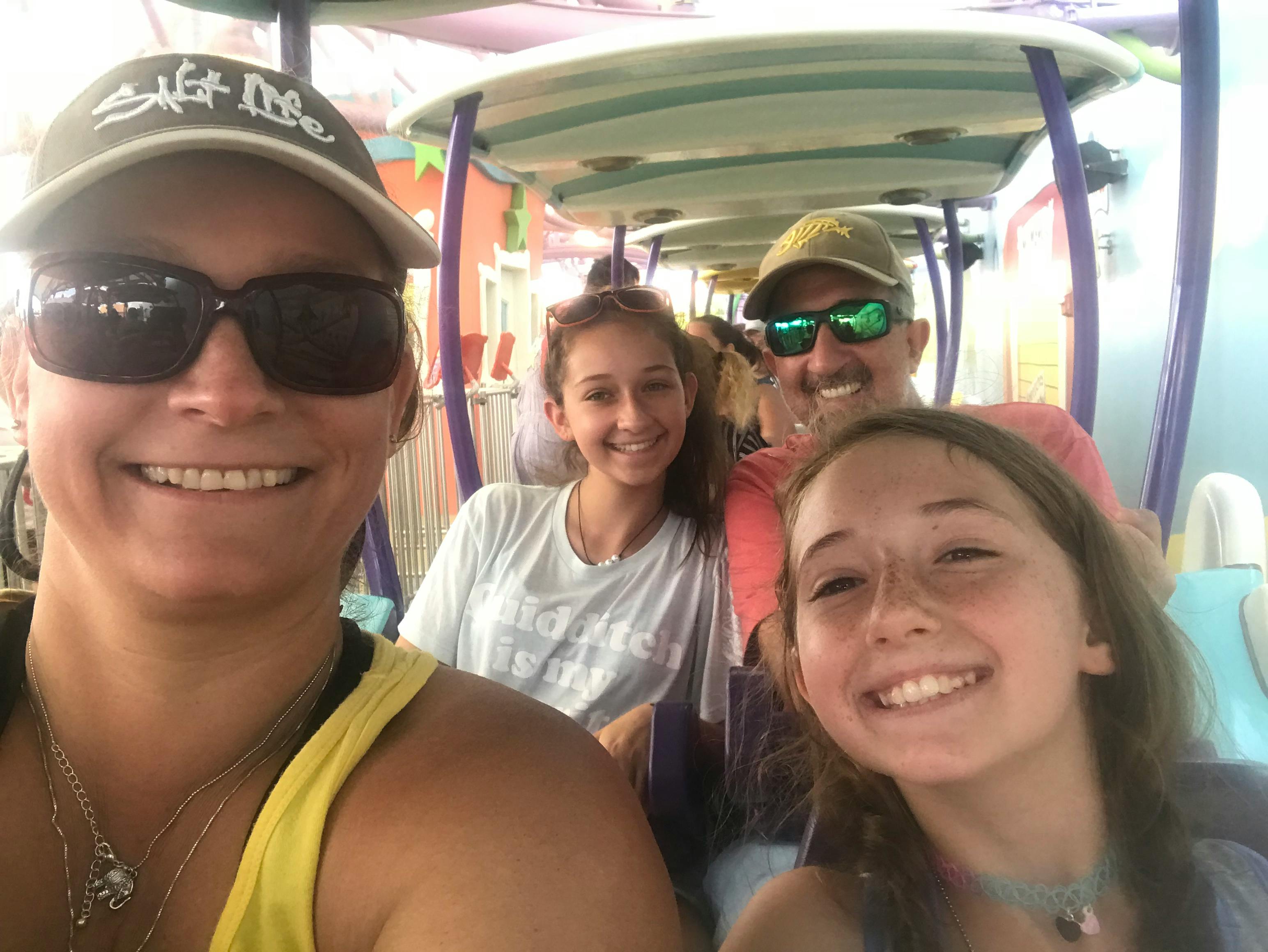 Four people smiling in a vehicle