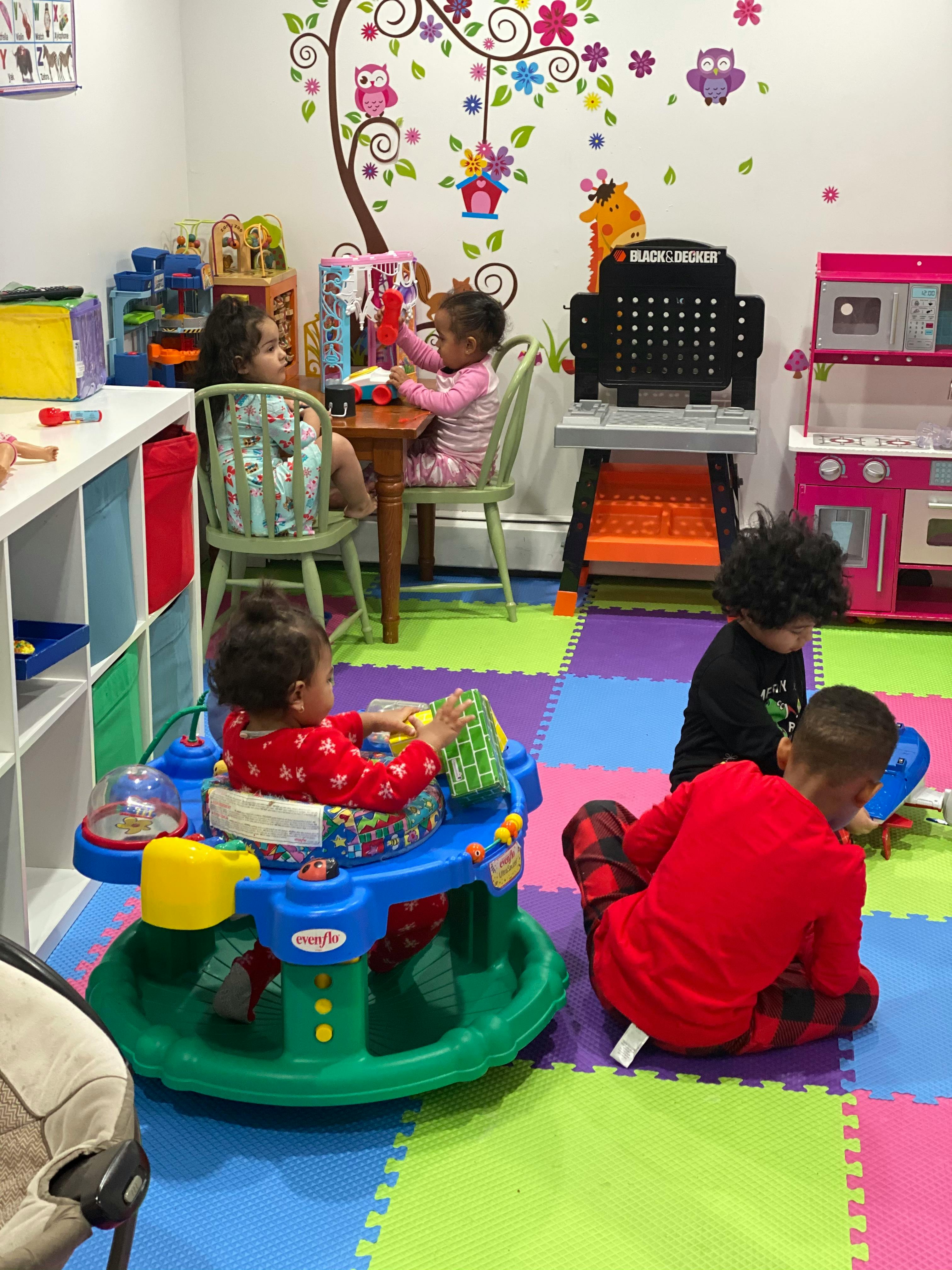 Four children playing with toys in a room