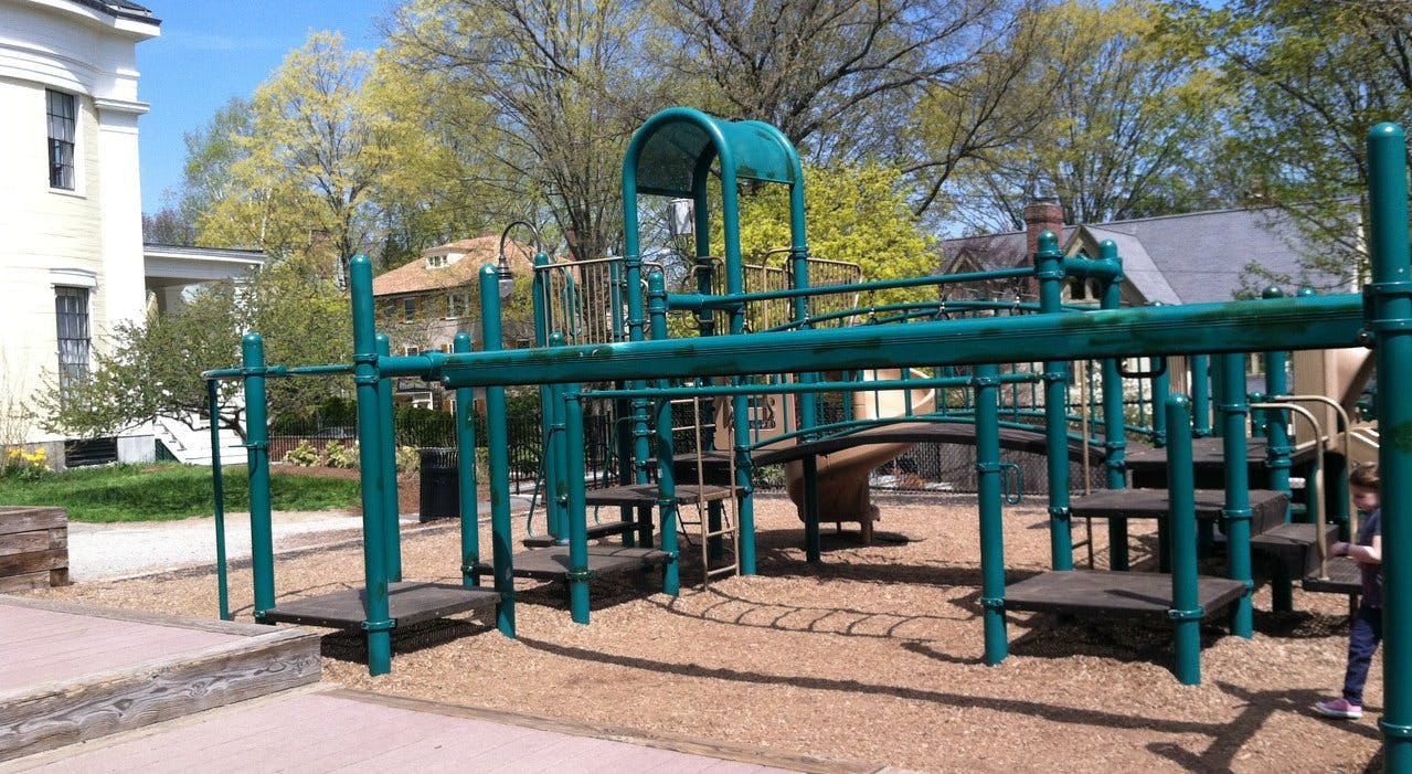 Playground structure with slides and climbing elements