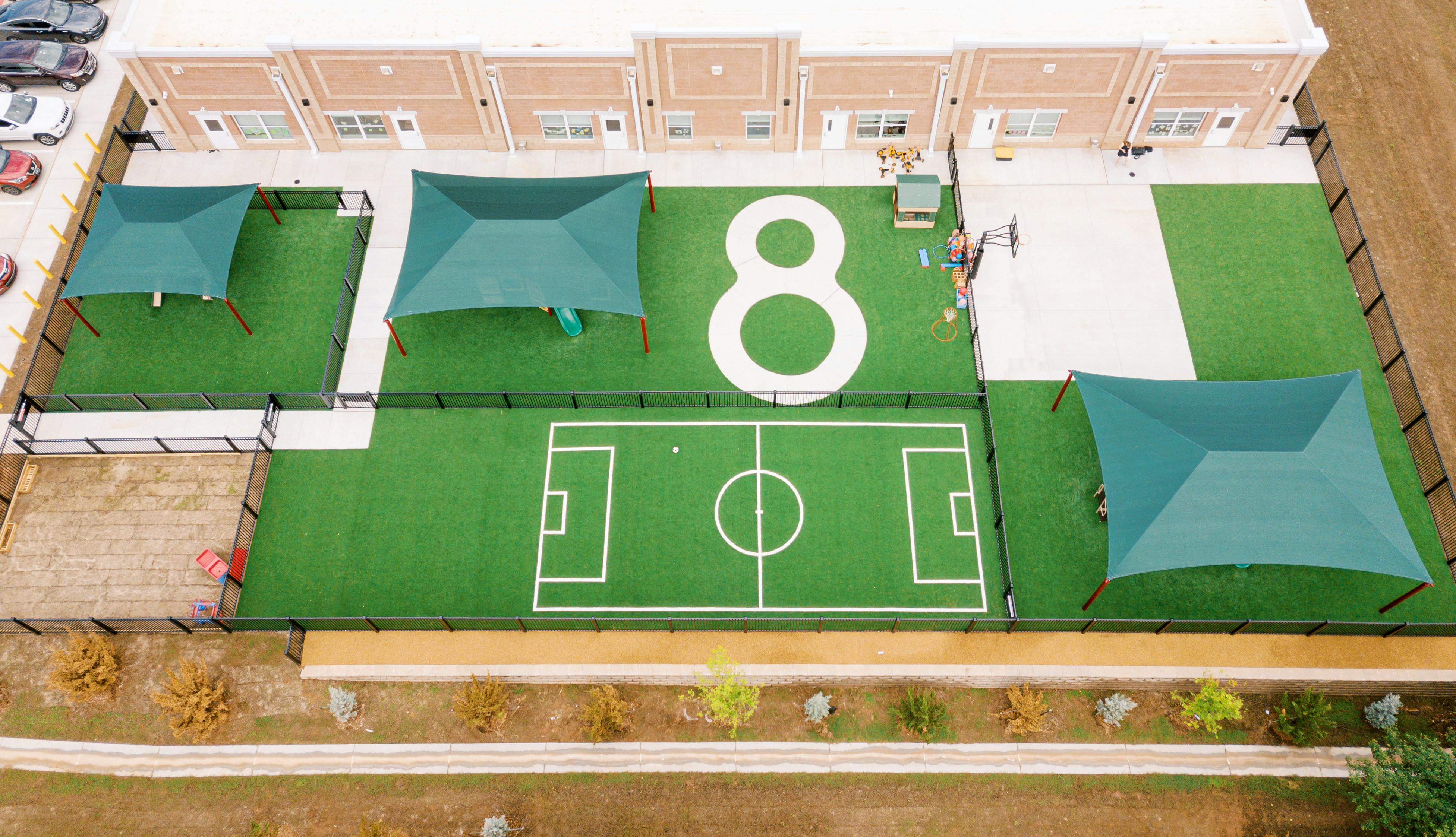 Aerial view of a playground with a soccer field and large number 8