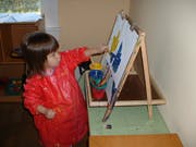 Child painting at an easel