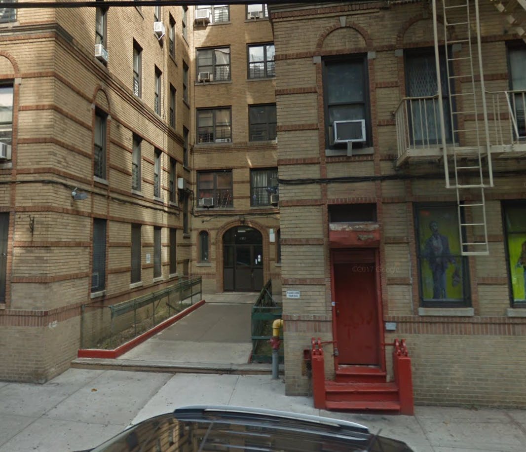 Brick apartment buildings with a red door and fire escape