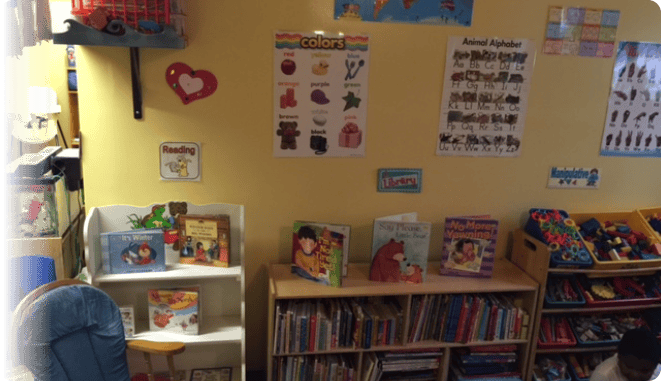 Classroom with bookshelves and educational posters on the wall