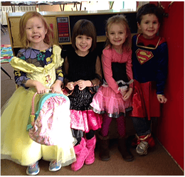 Four children in costumes standing together