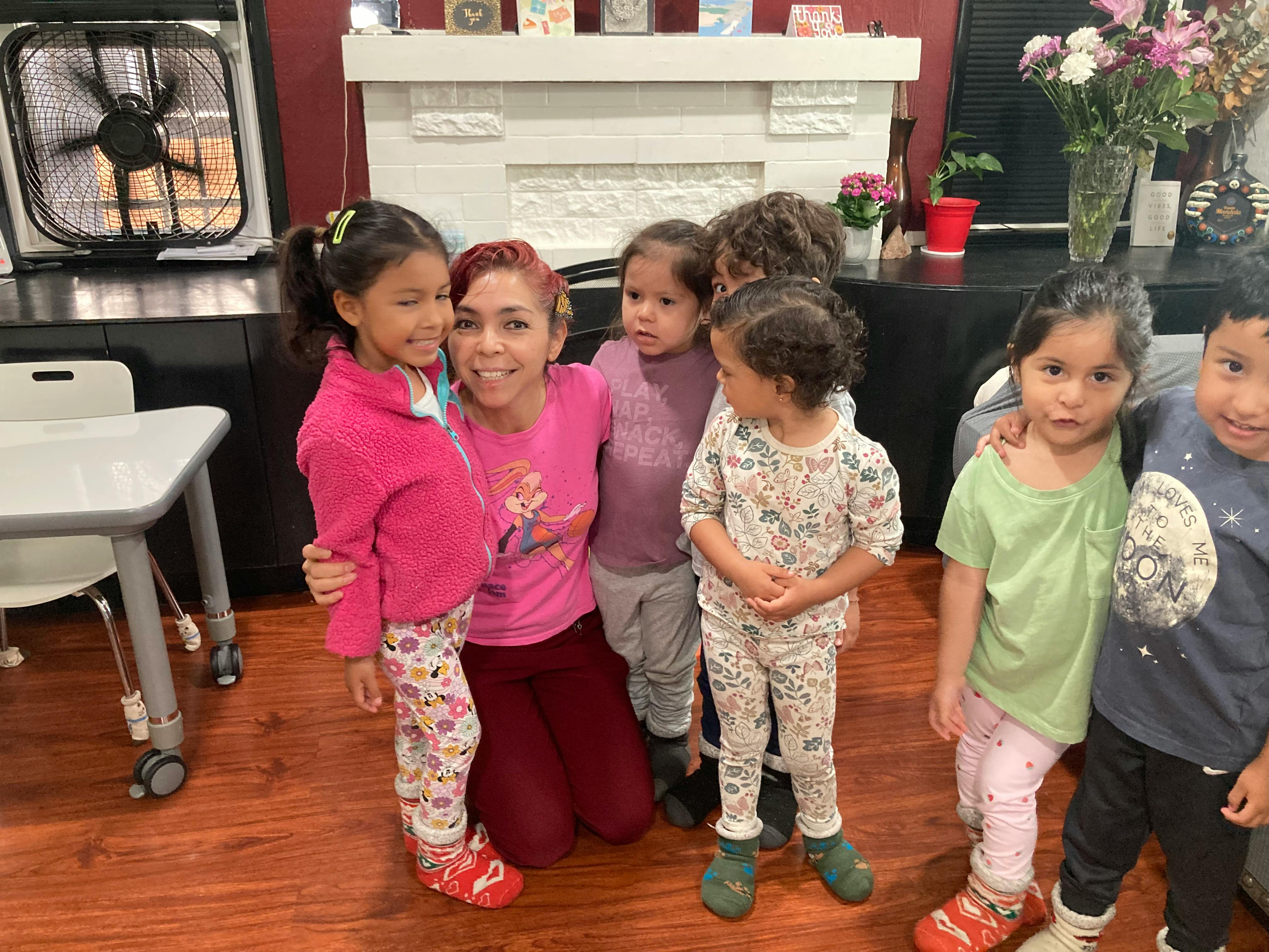 One adult and six children posing for a photo indoors