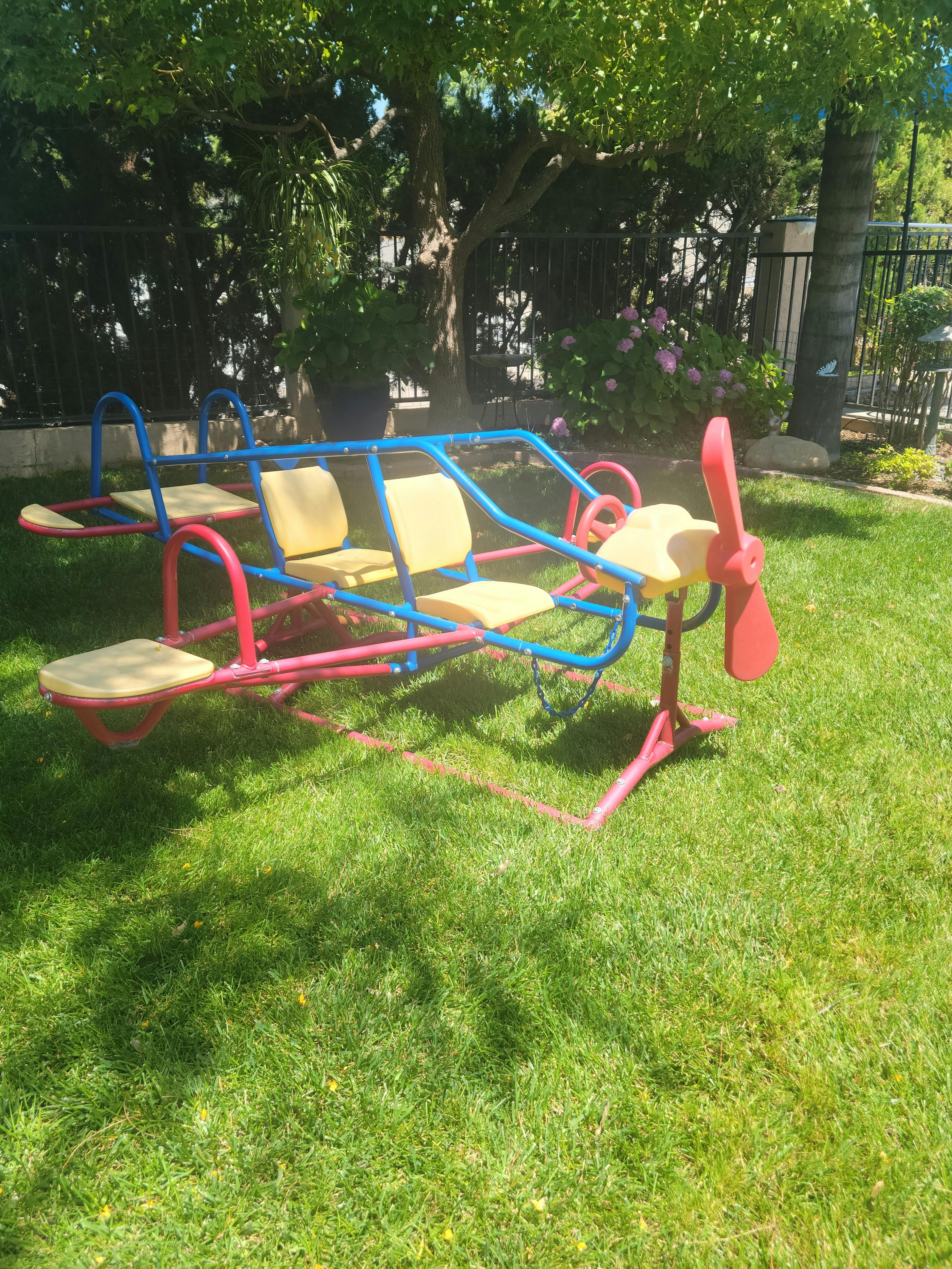 Airplane-shaped seesaw on grass