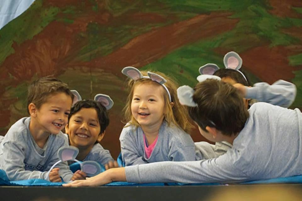 Children wearing mouse ear headbands and gray shirts