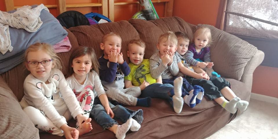 Six children sitting on a couch