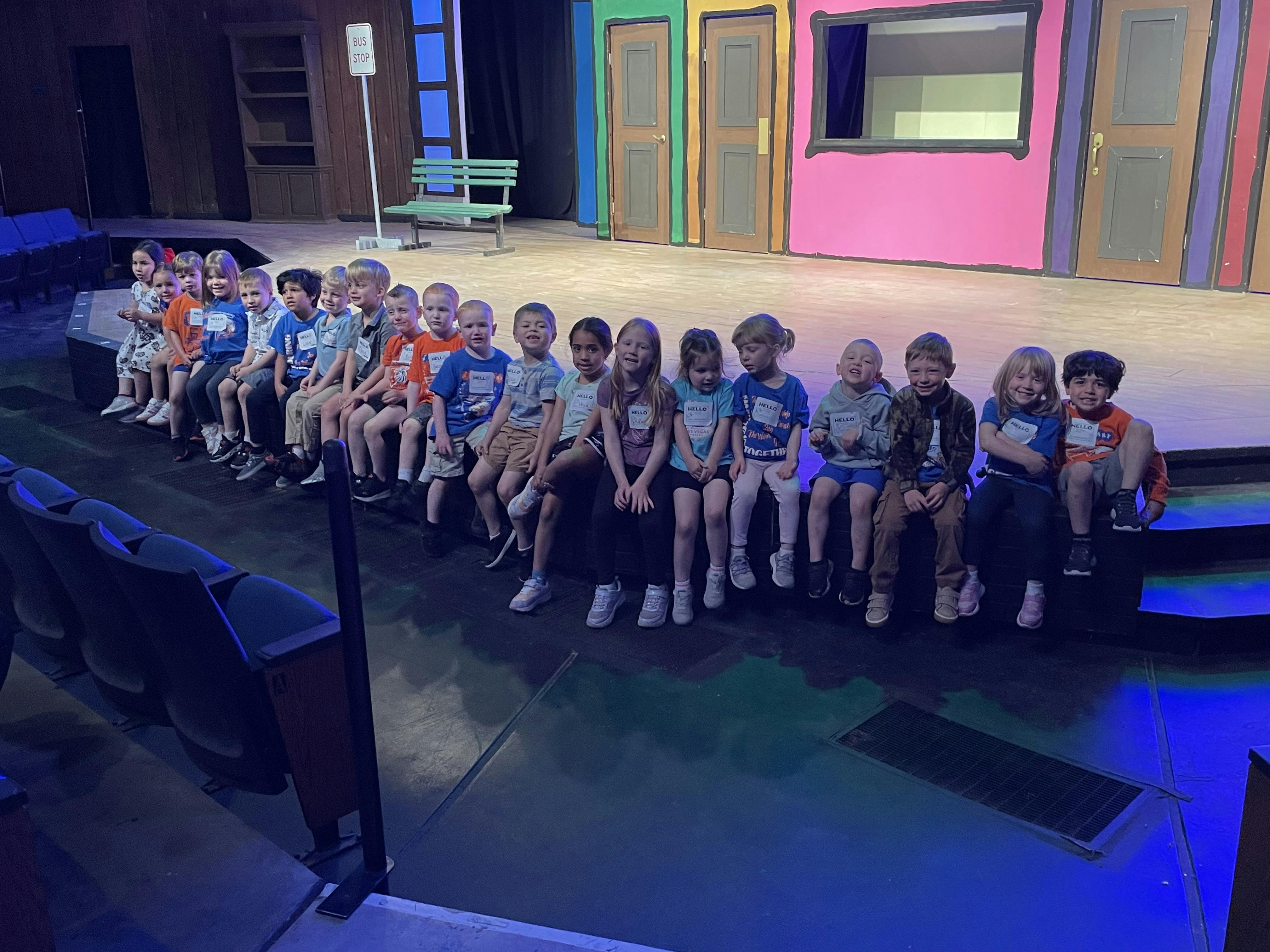 Group of children sitting on a stage