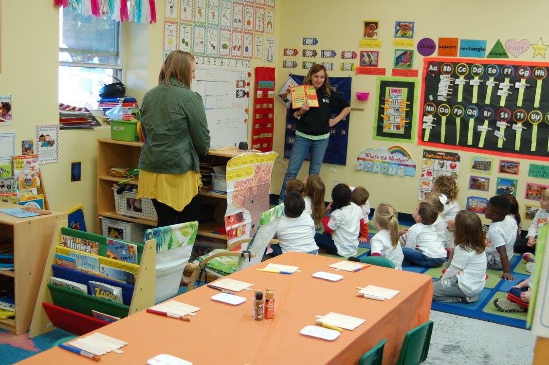 Person teaching a group of children in a classroom