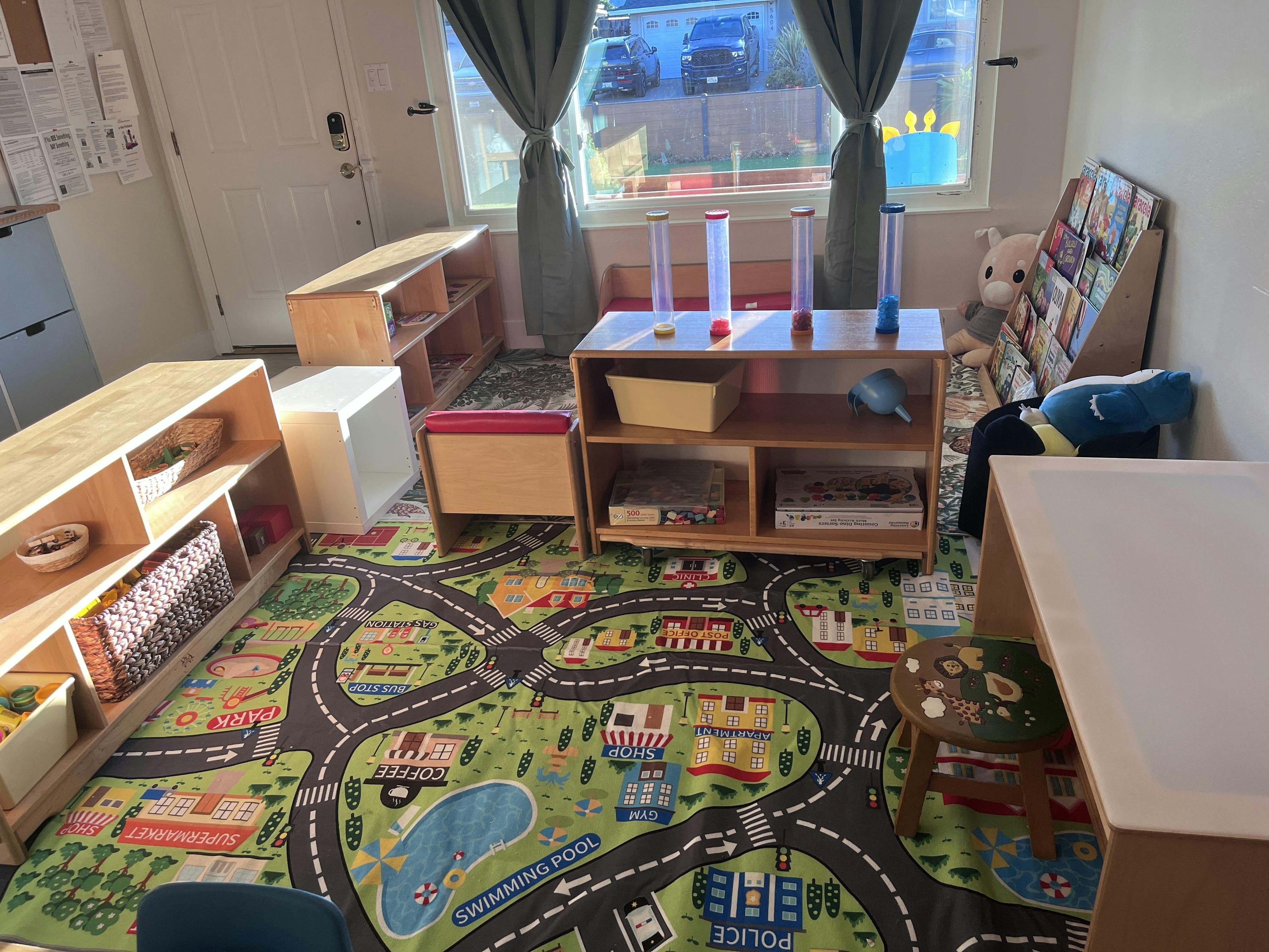 Childcare classroom with furniture and a town map floor rug