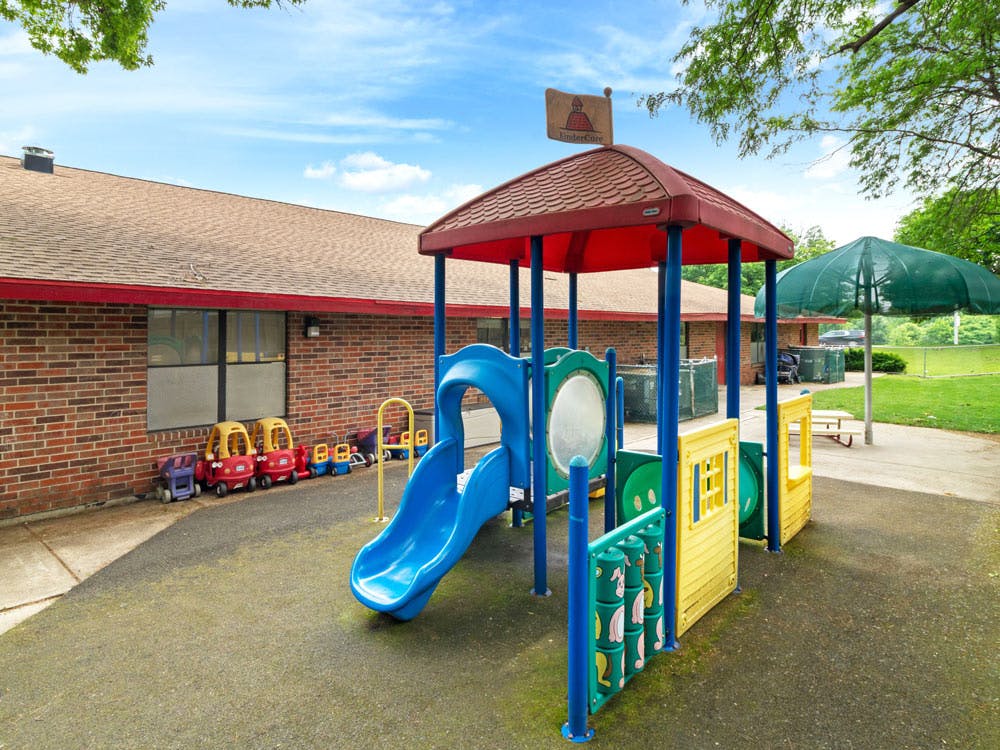 Outdoor playground with a blue slide and other play structures