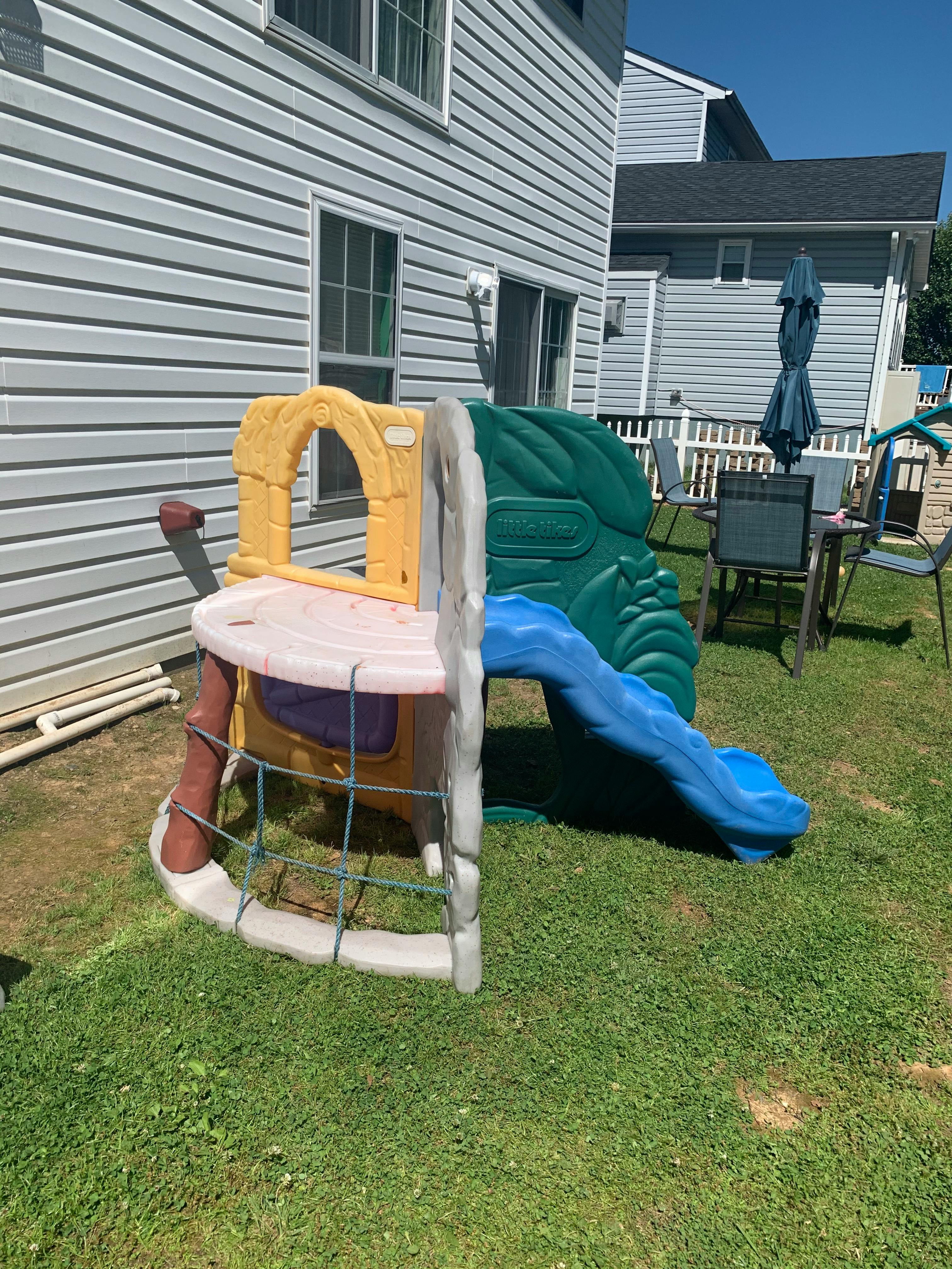 Children's outdoor play structure with slide