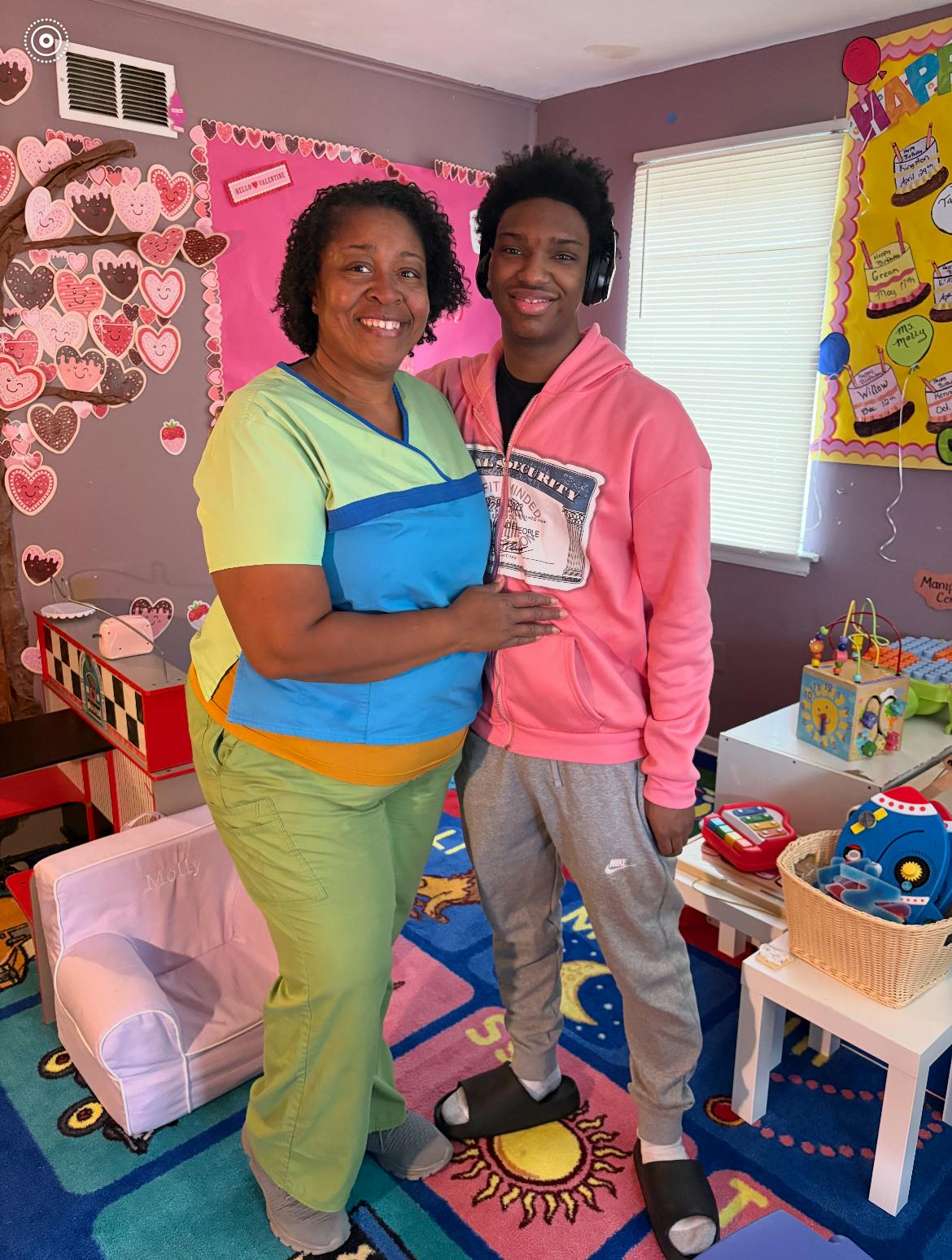 Adult person and teen standing together in a decorated room