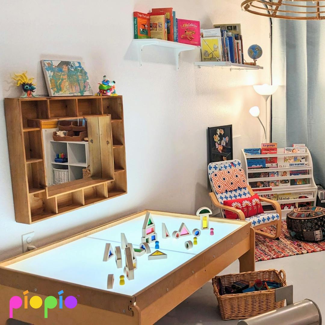 Playroom with a light table, shelves, and a chair