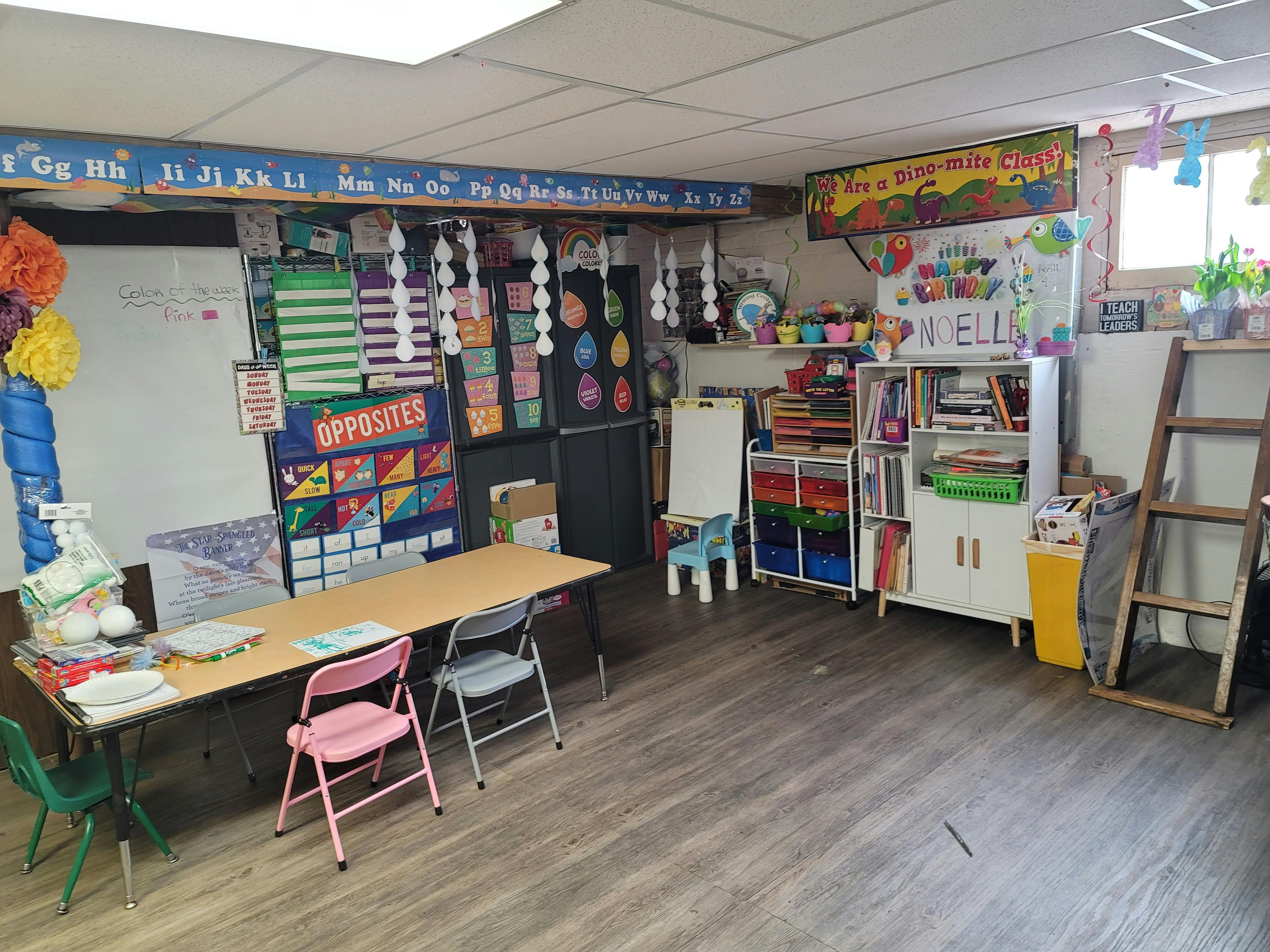 Classroom with tables, chairs, and learning decorations