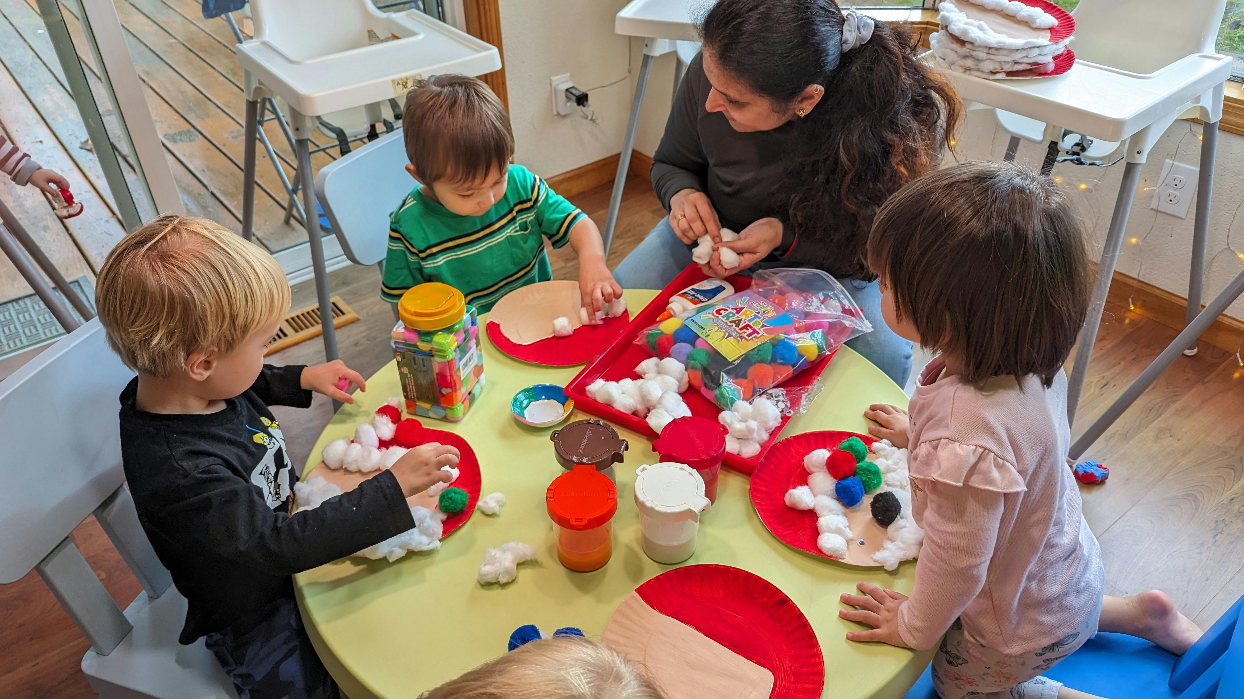 Adult and children doing crafts at a table