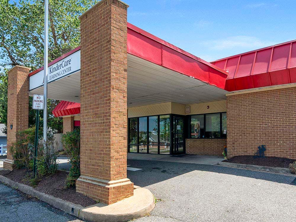 Entrance to a KinderCare Learning Center with a red roof