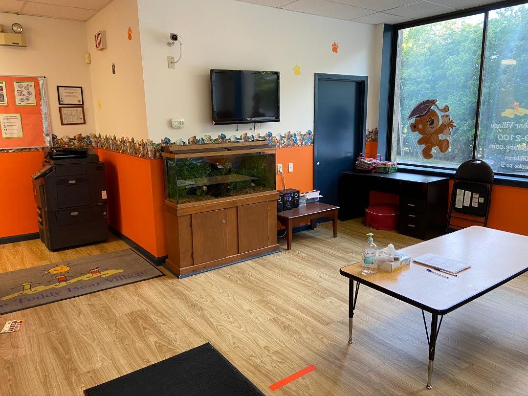 Classroom with a fish tank, television, and tables
