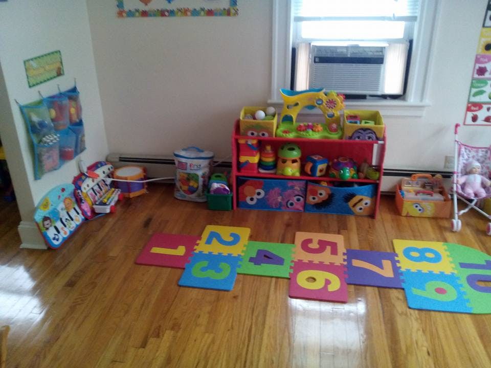 Playroom with colorful number floor mats and toy shelves