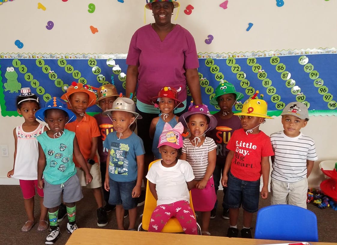 Adult and multiple children wearing hats