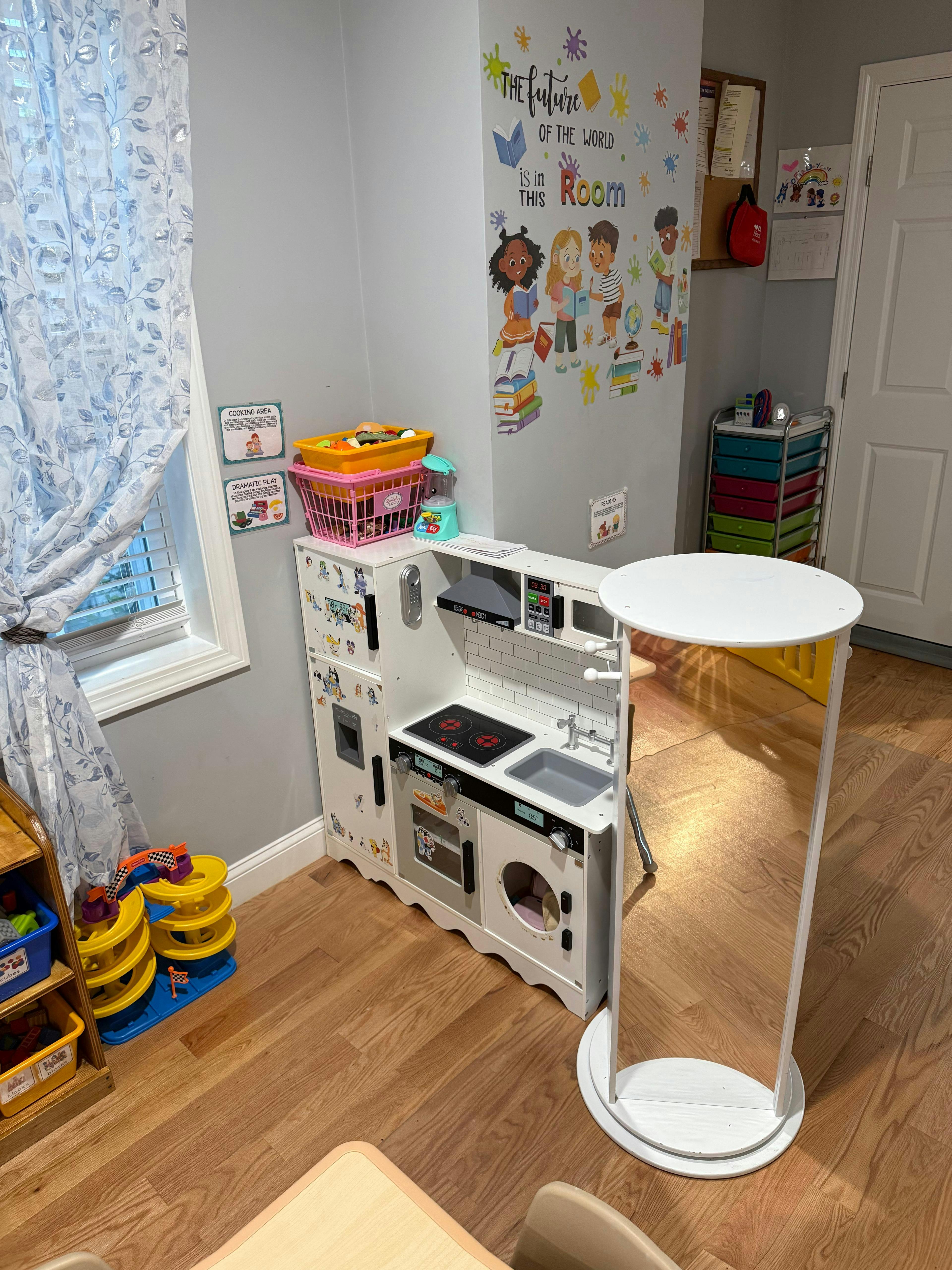 Child's play kitchen with a sink, stove, and oven