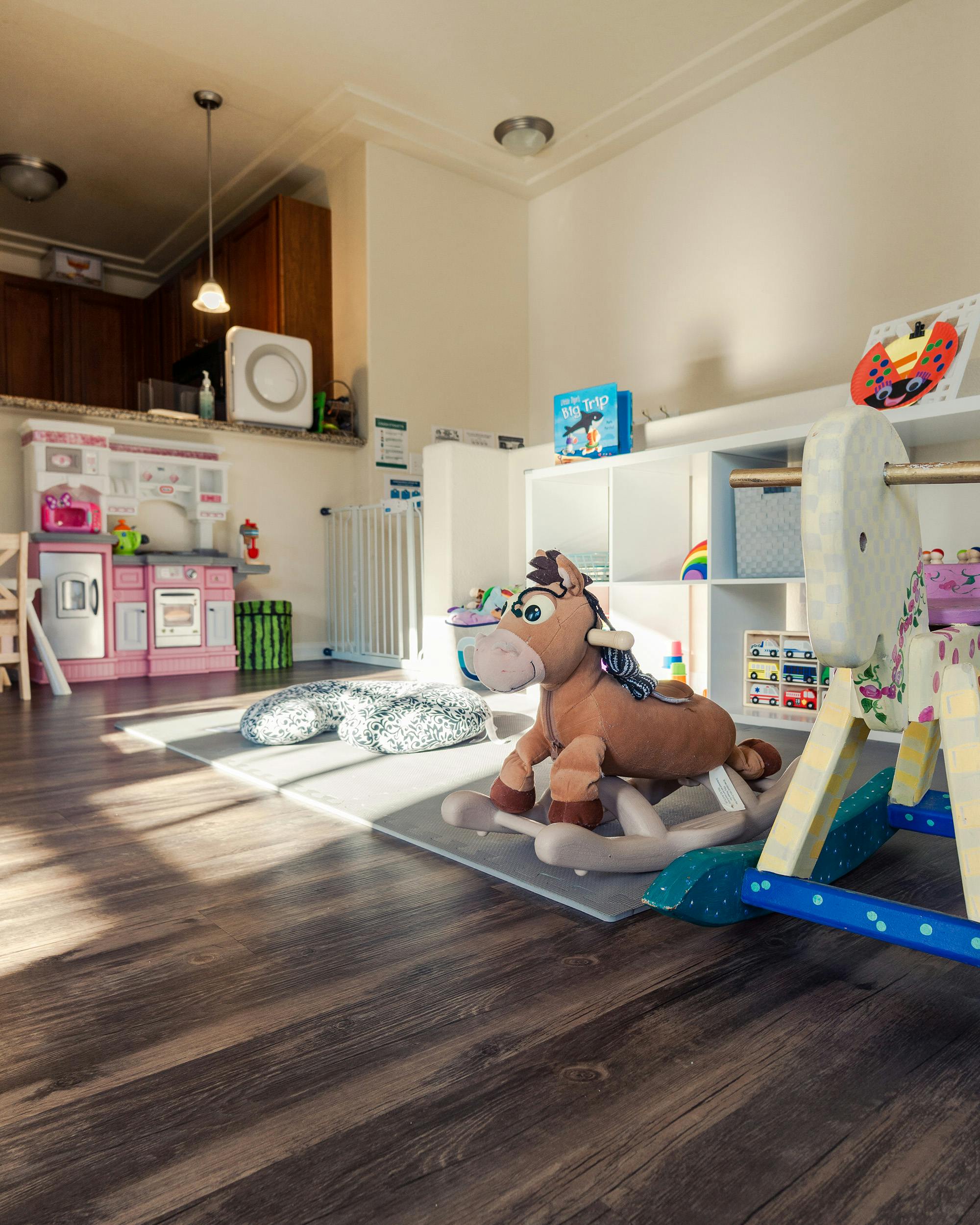 Playroom with toy kitchen and rocking horse