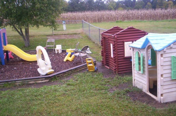 Playground with slide, playhouses, and swing set