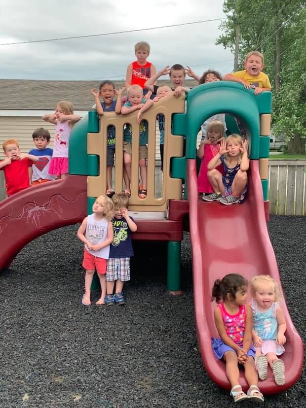 Children playing on a playground structure with slides