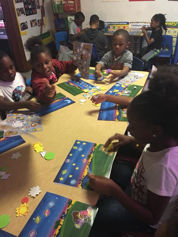 Children sitting around a table doing crafts