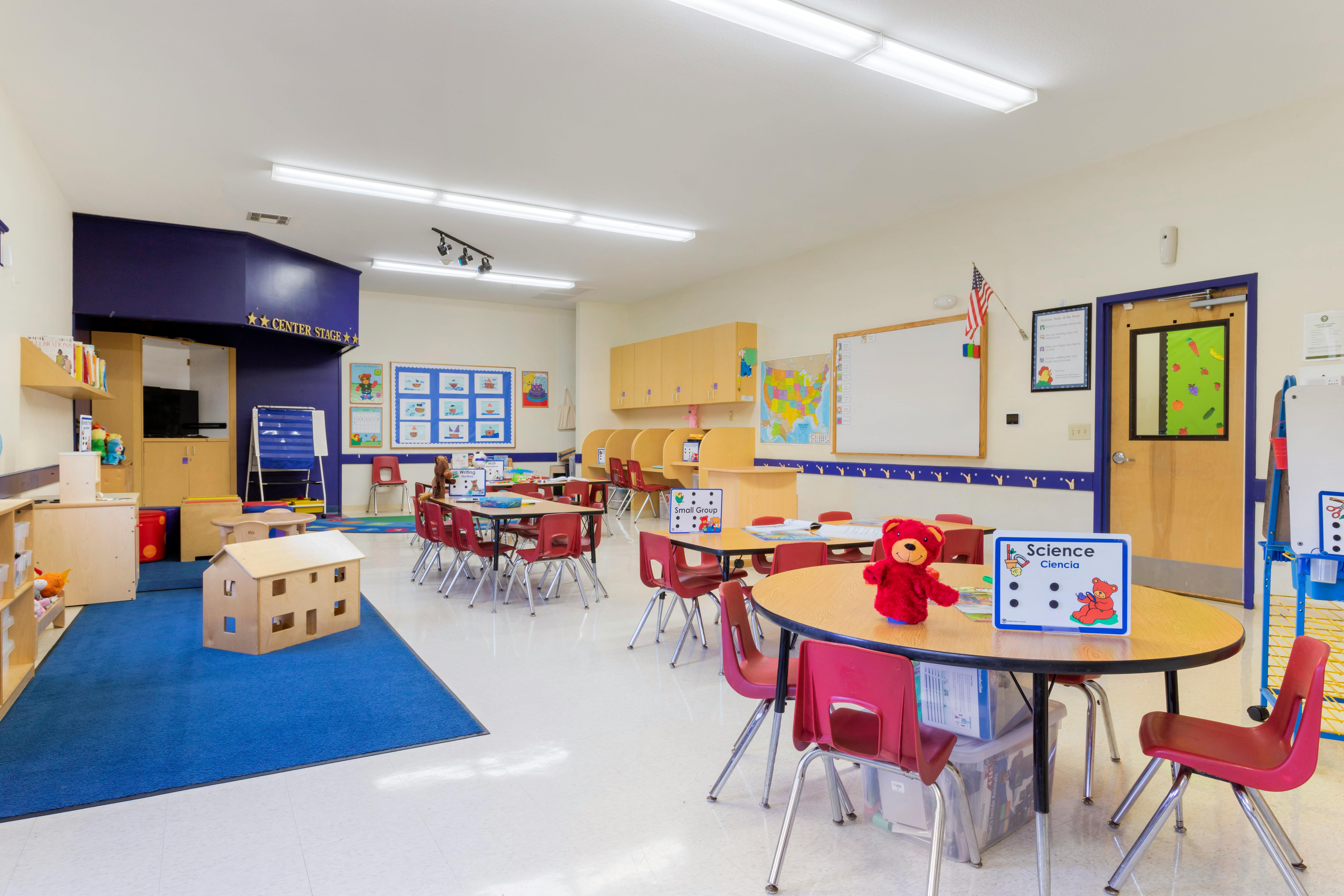 Classroom with tables, chairs, bookshelves, and a 'Science' sign