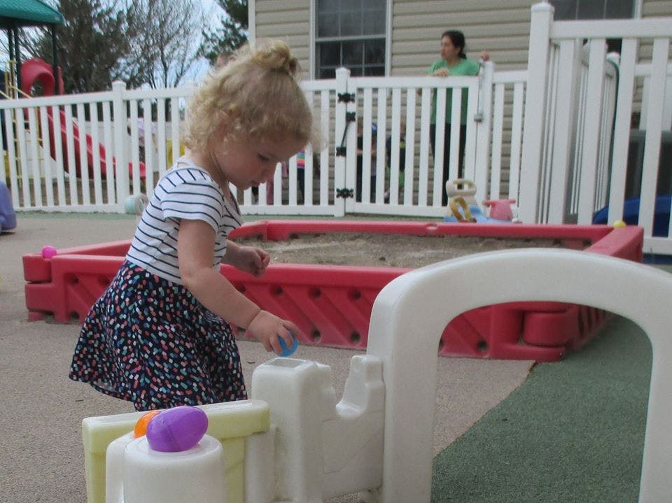 Child playing with toys in an outdoor area