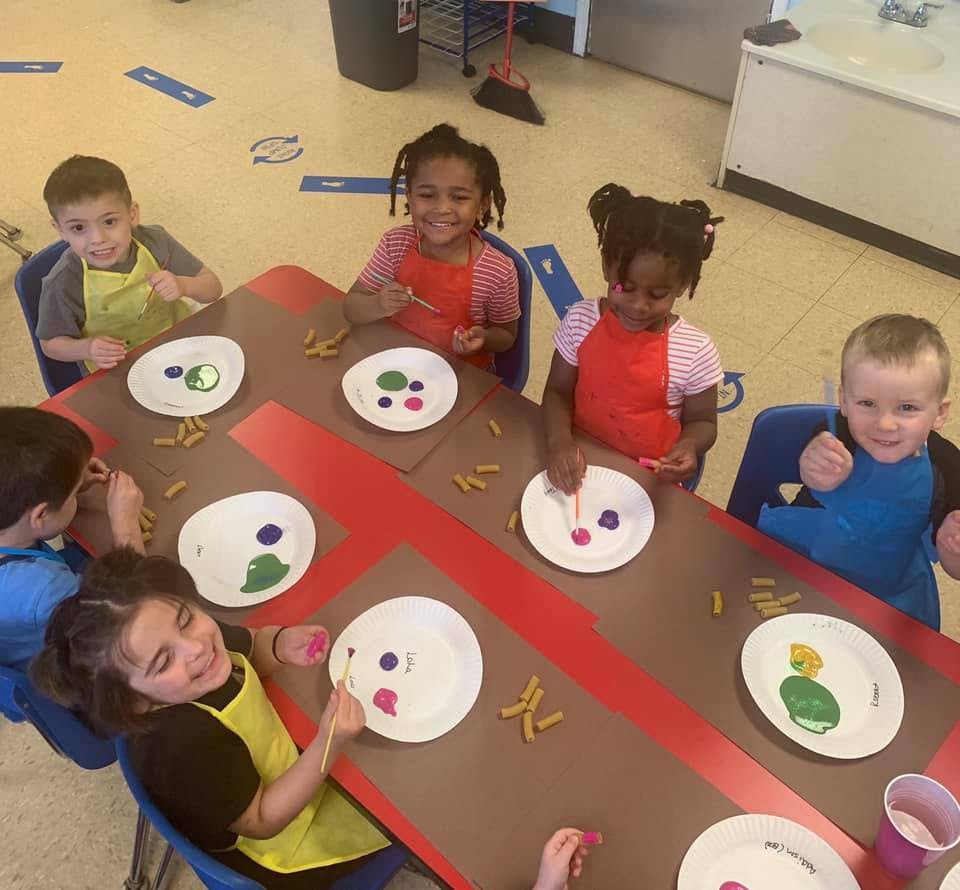 Children painting at a table