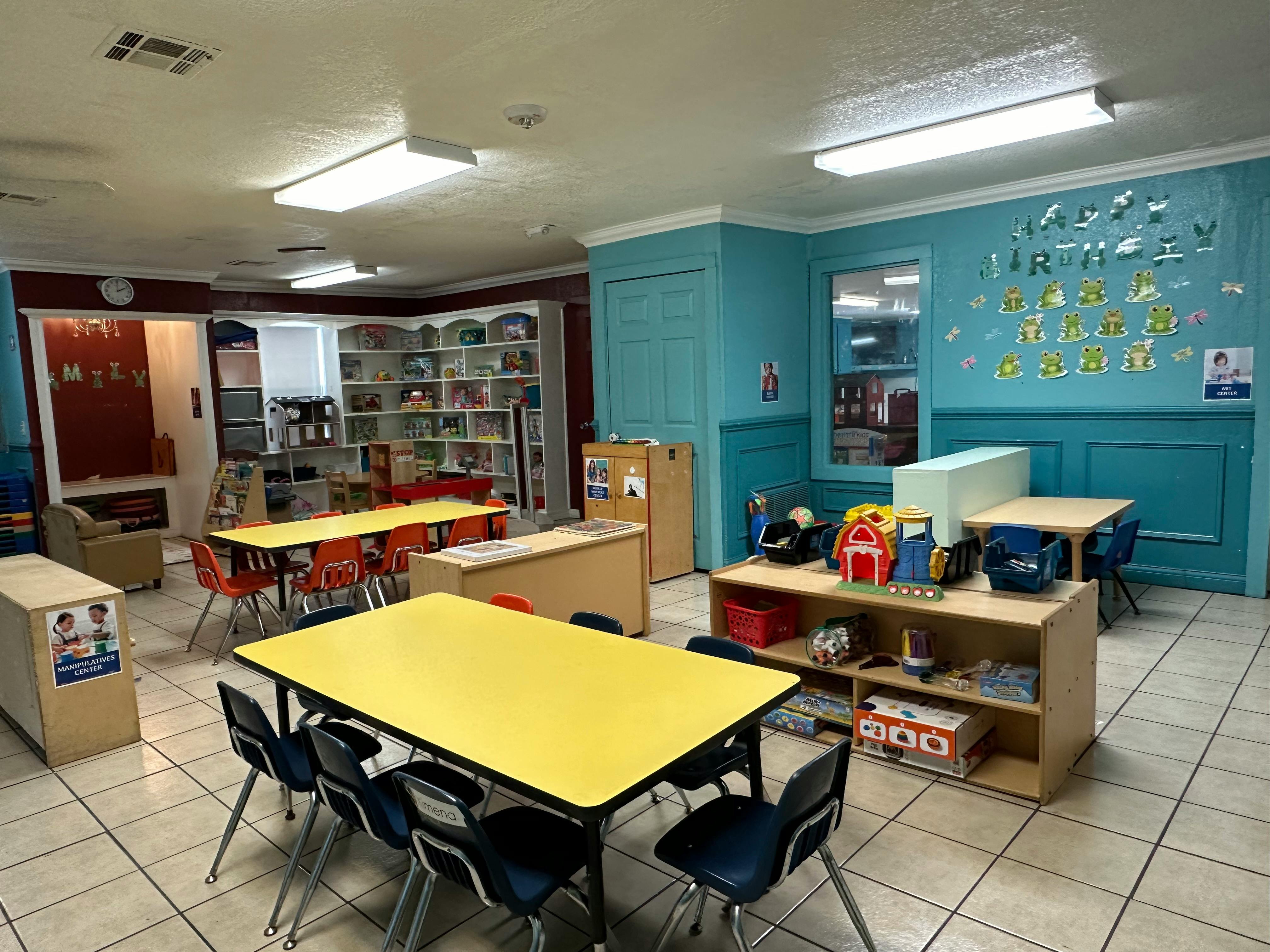 Classroom with yellow tables and blue chairs