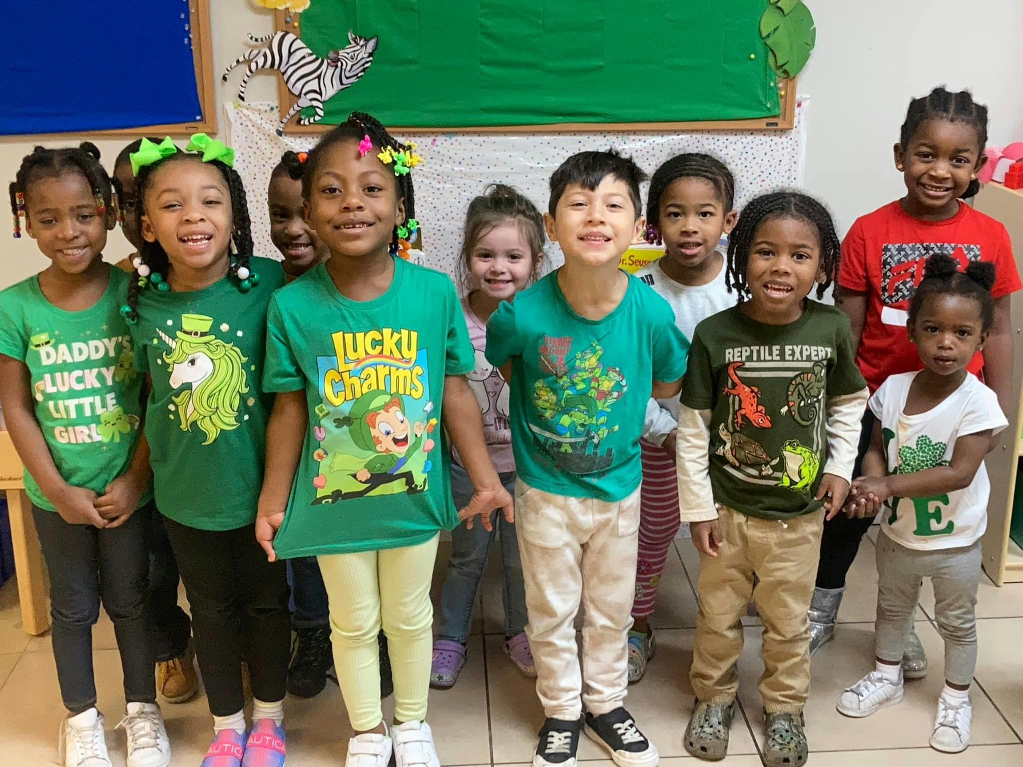 Group of children in green shirts standing together
