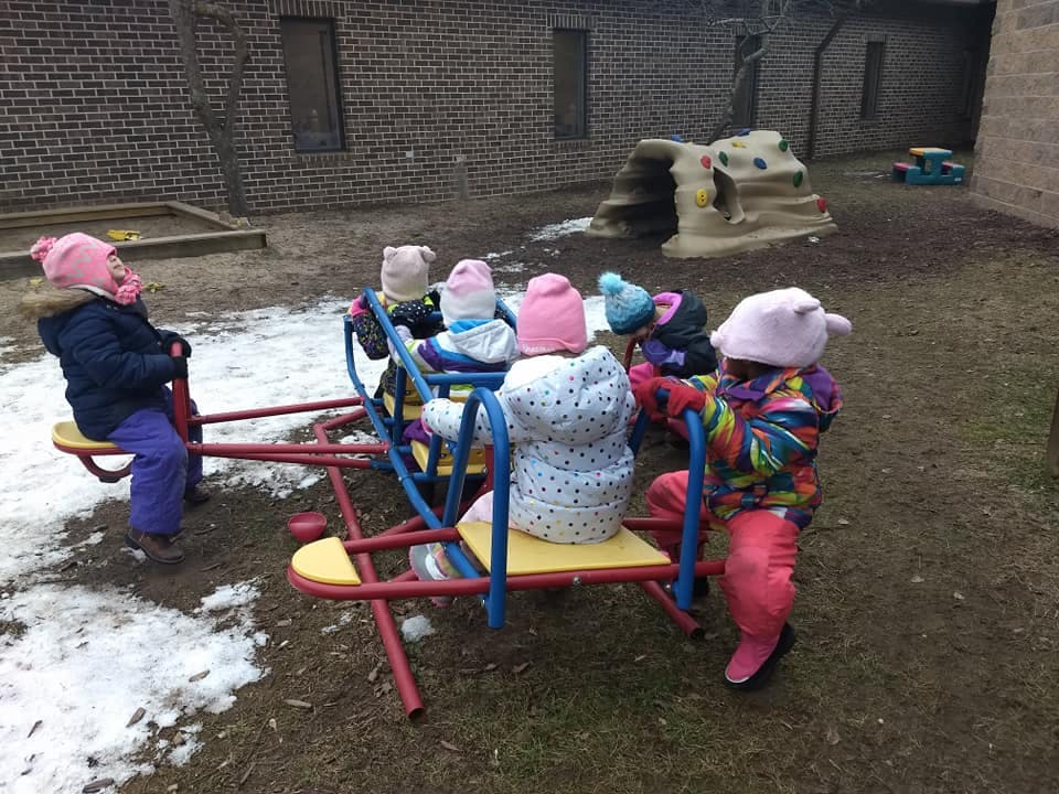 Children playing on a seesaw in a playground