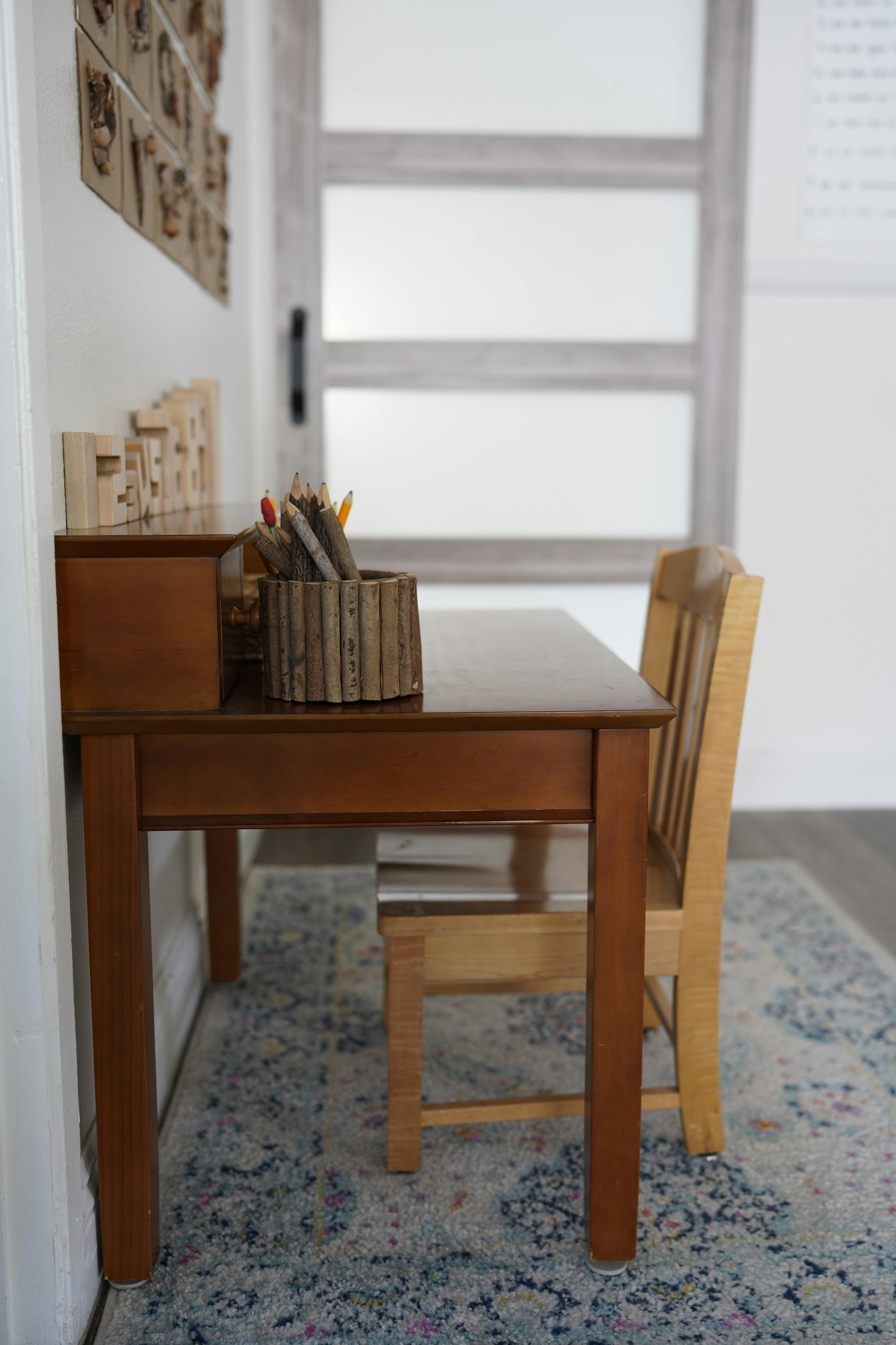 Wooden desk with a pencil holder and a chair