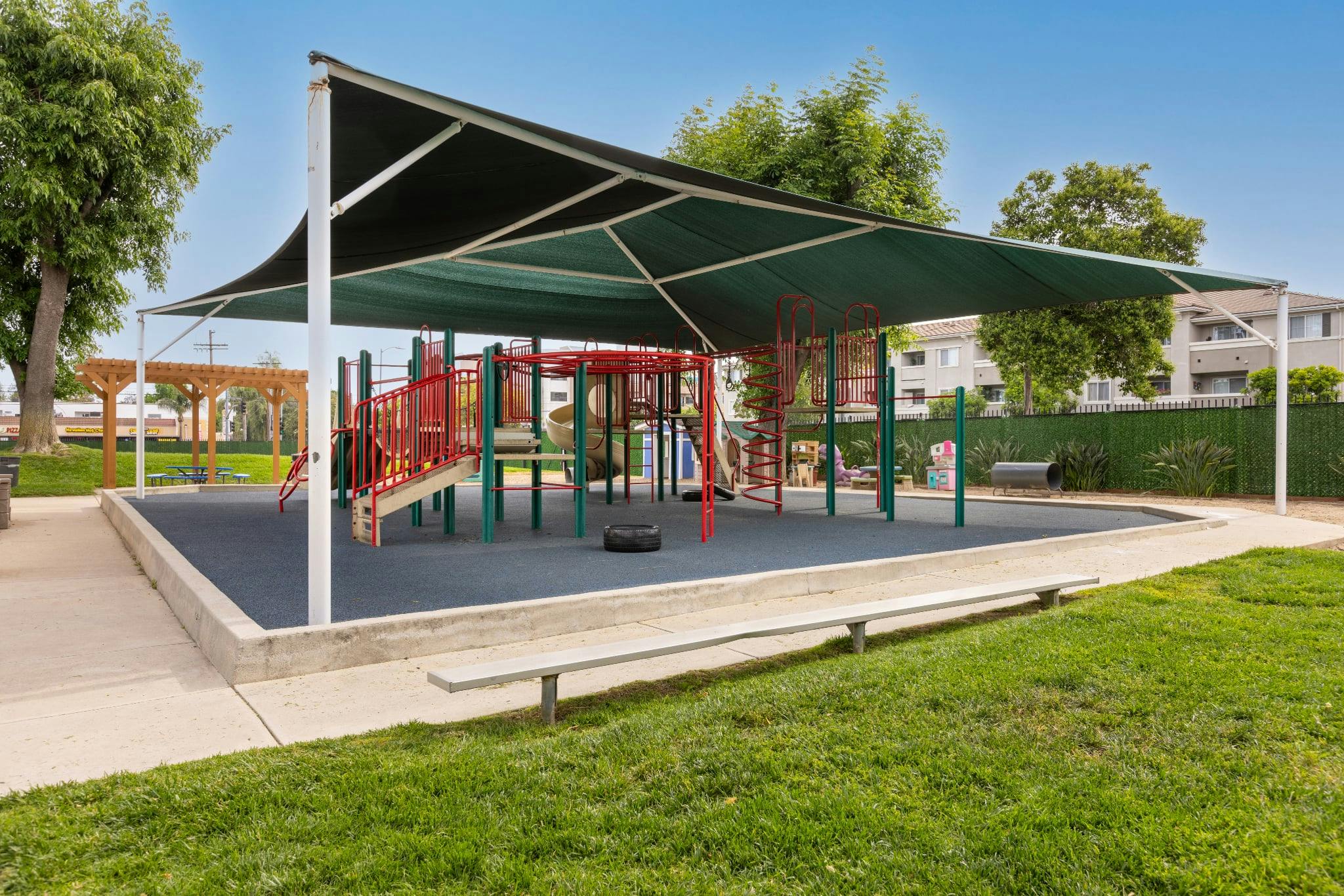 Empty children's playground with a large shaded structure