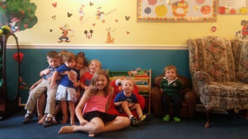 Group of children and teens posing in a room