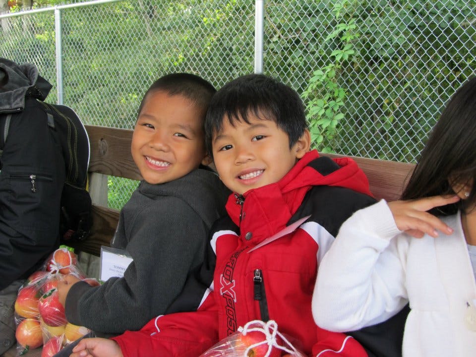 Two children sitting on a bench