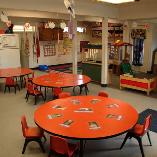 Classroom with orange tables and chairs