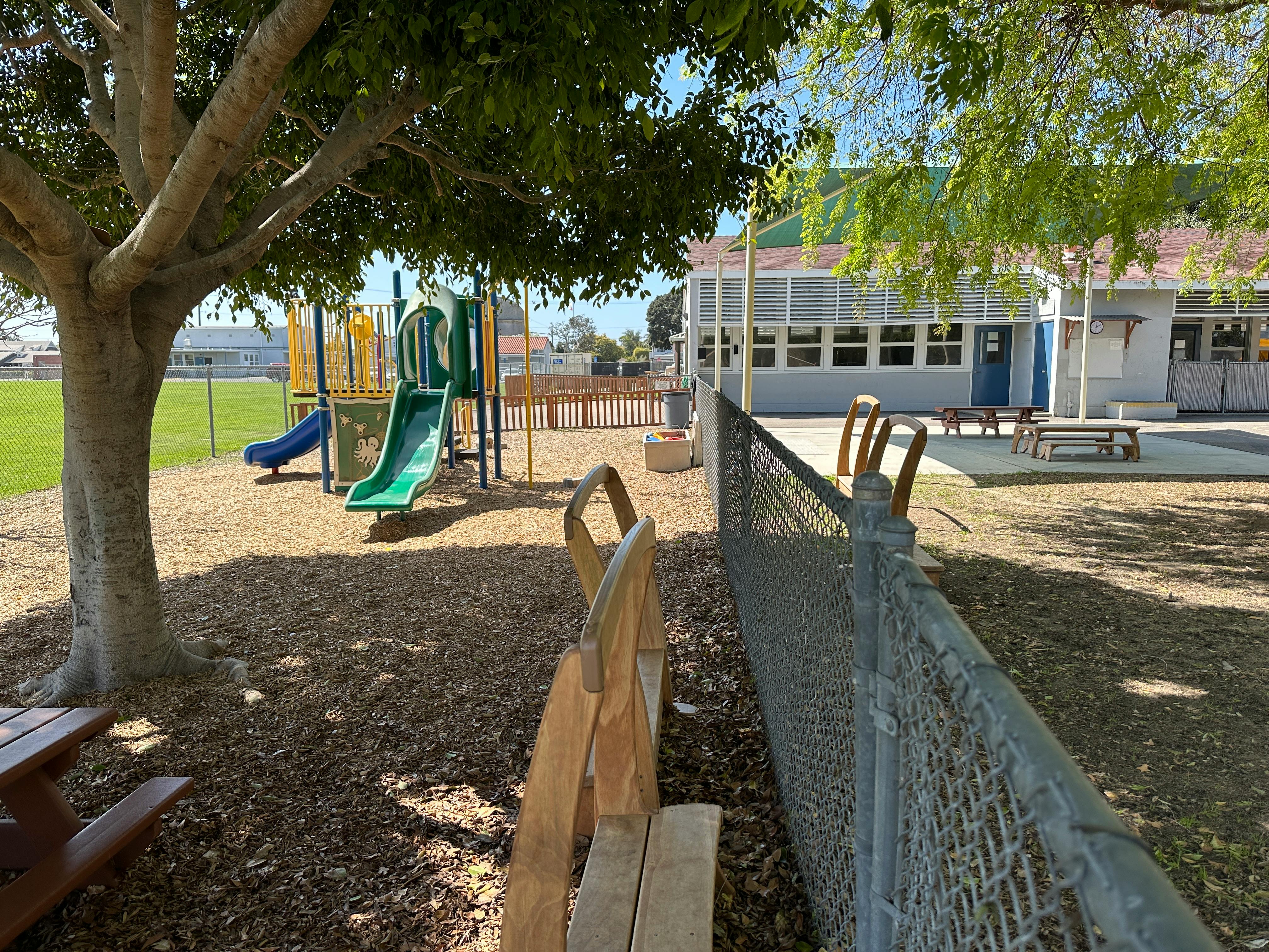 Playground with slides and swings next to a building