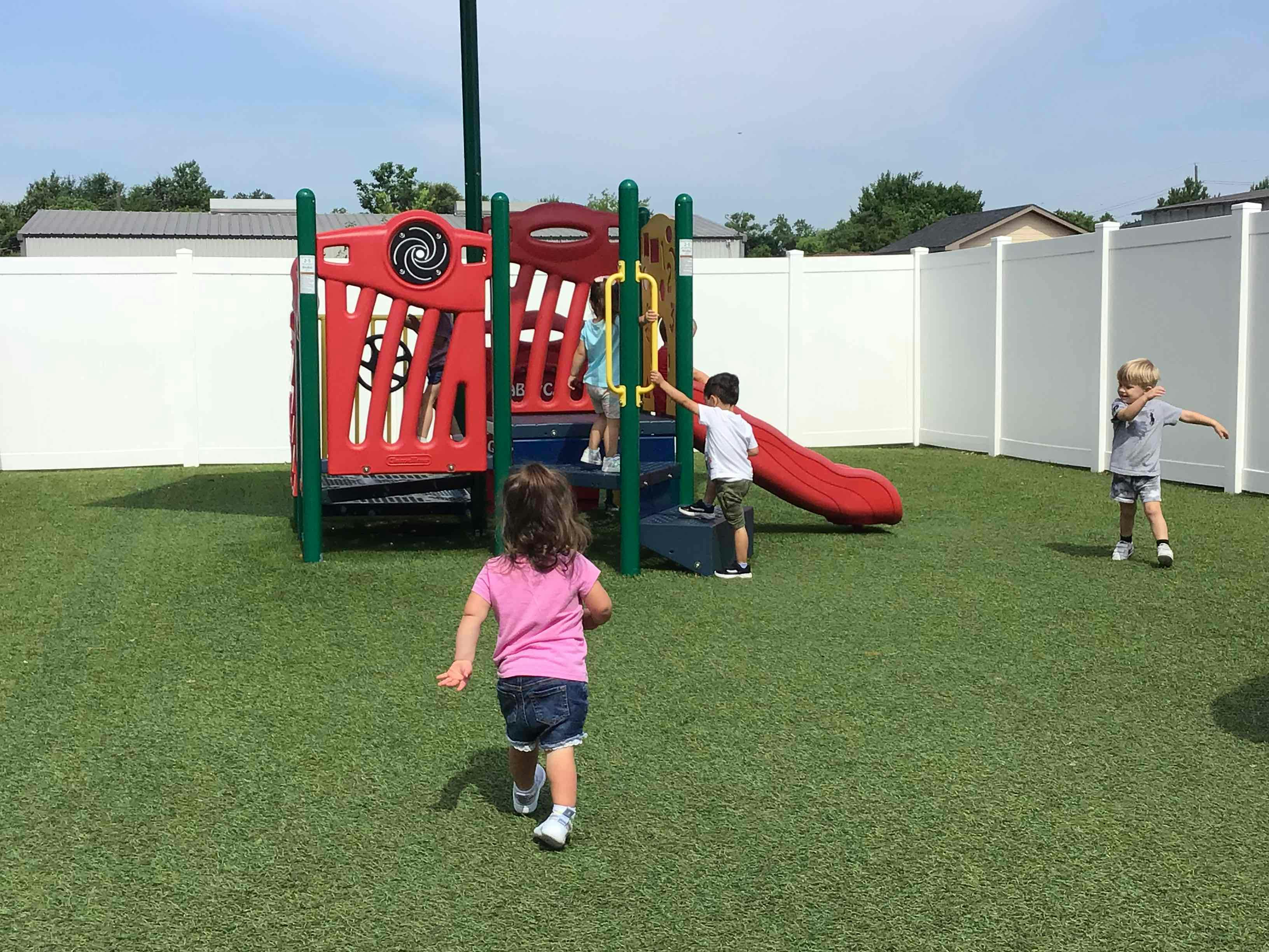 Children playing on a playground structure with a slide