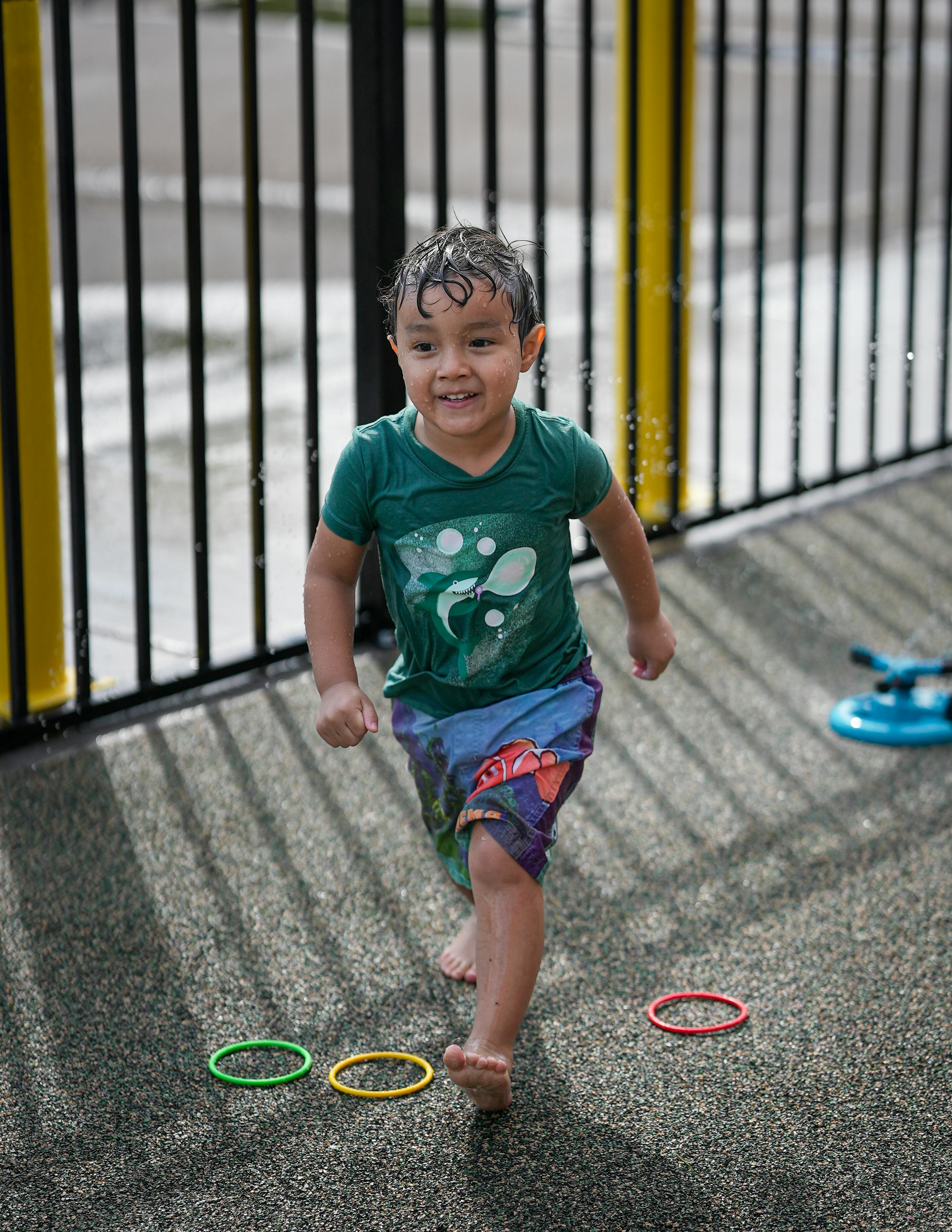 Child running barefoot on a wet surface