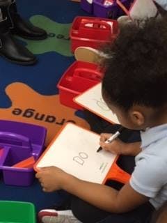 Child drawing on a white board
