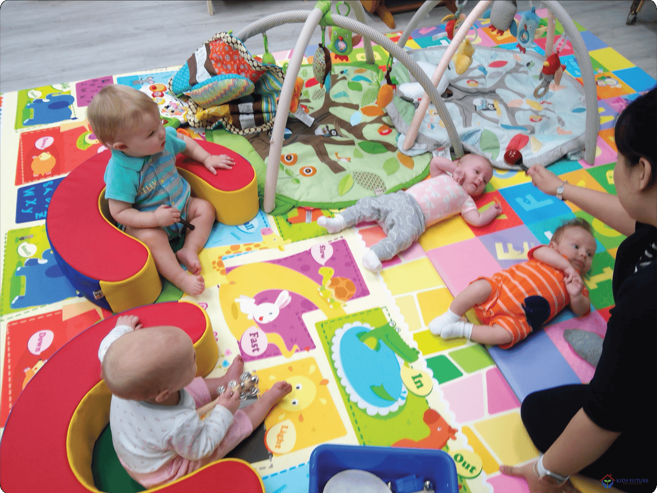 Adult and multiple children on a colorful playmat