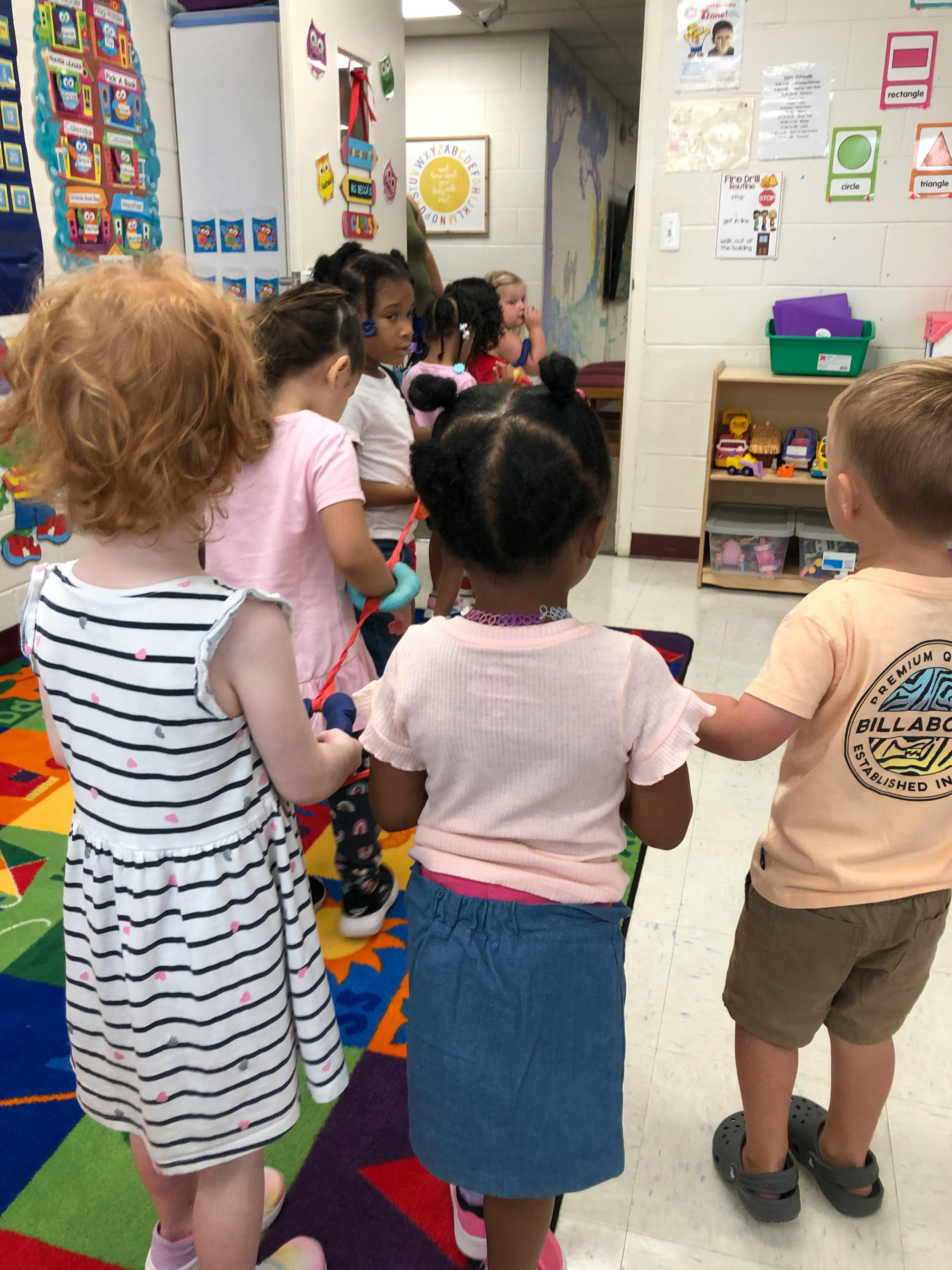 Children standing in a line in a classroom