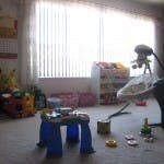 Child's play table and toys in a room with a bright window